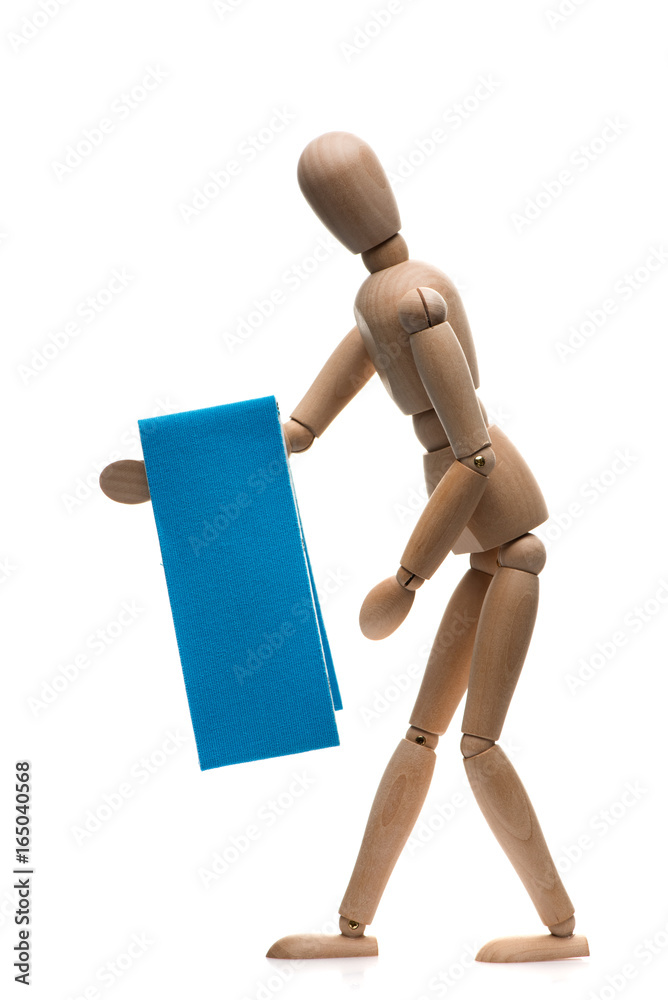 wooden man holds a kinesio tape. Kinesiotaping concept wooden man holds a kinesio tape. Kinesiotaping concept