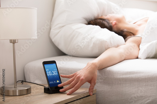 Woman Turning Off The Alarm