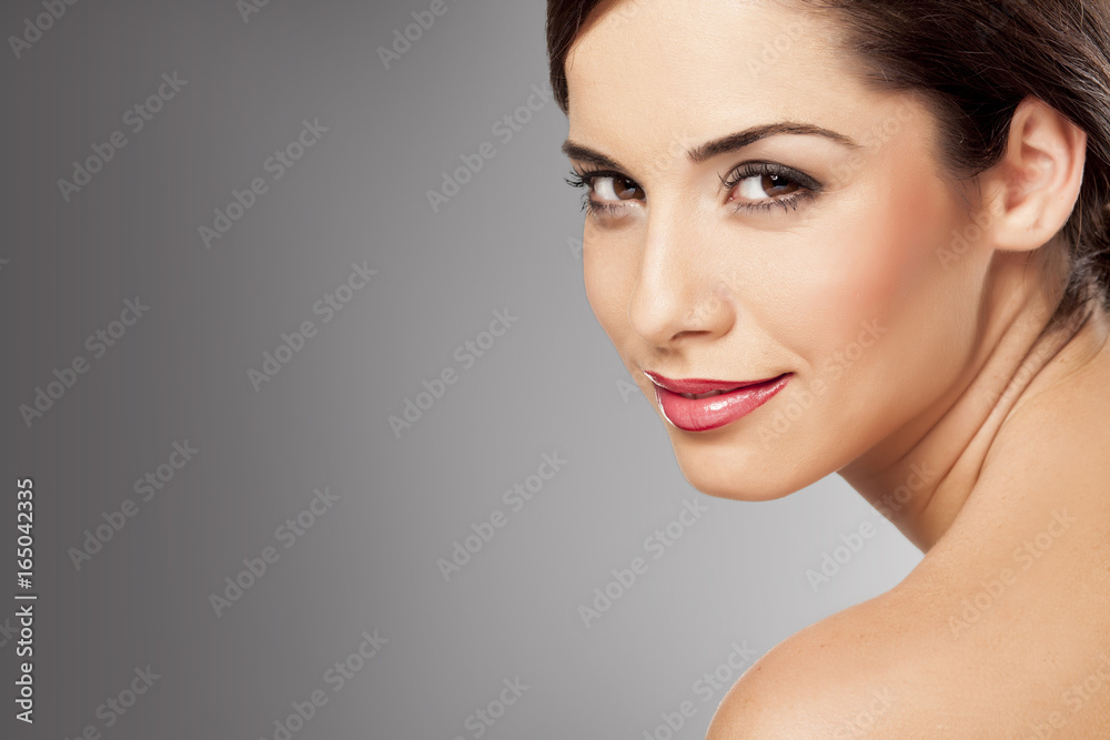 portrait of a young beautiful woman on gray background portrait of a young beautiful woman on gray background