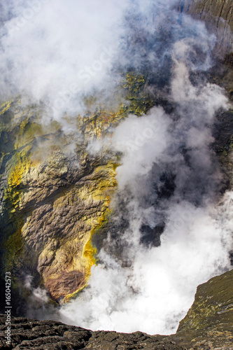 Active Bromo volcano mountain hole with sulfur gas and smoke