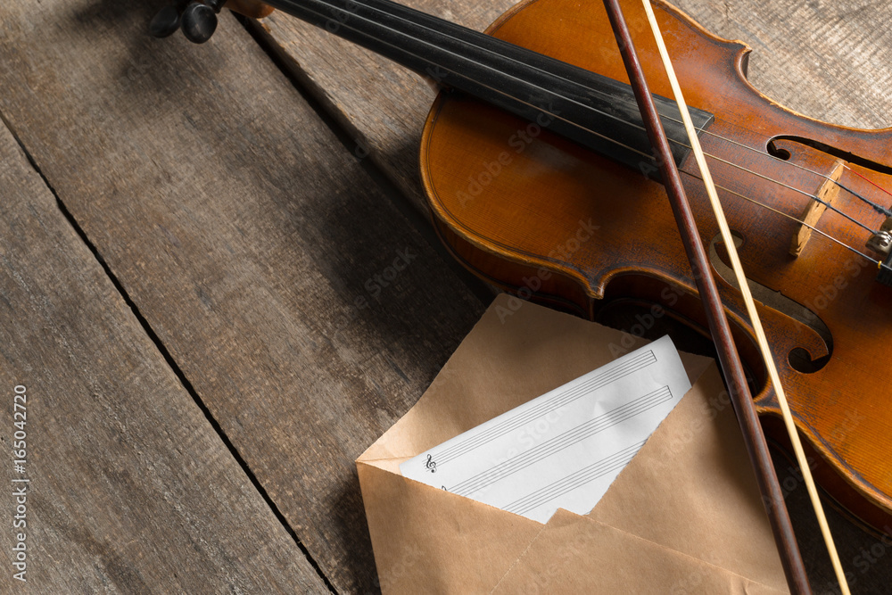 Sheet music and violin on wooden table Sheet music and violin on wooden table