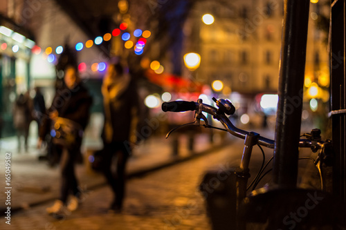 People wandering in the streets of Paris at night