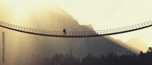 Man with backpack on a rope bridge photo