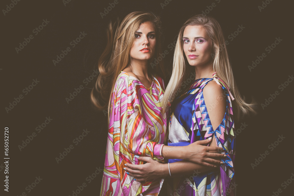 Fototapeta premium two blonde young women beauty fashion portrait in colorful silky dress