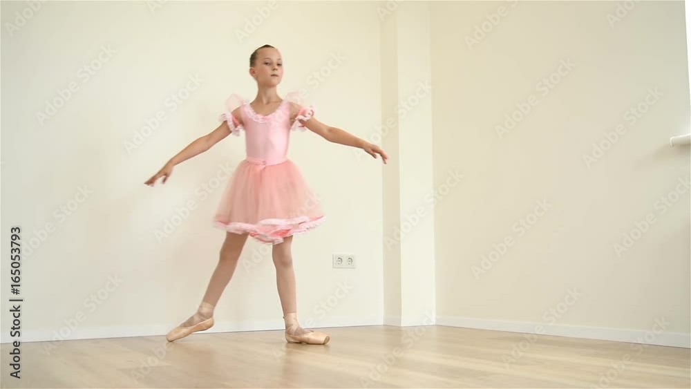 Young Ballerina In Pink Dress Doing Workout In Room. Slow Motion Effect Young Ballerina In Pink Dress Doing Workout In Room. Slow Motion Effect