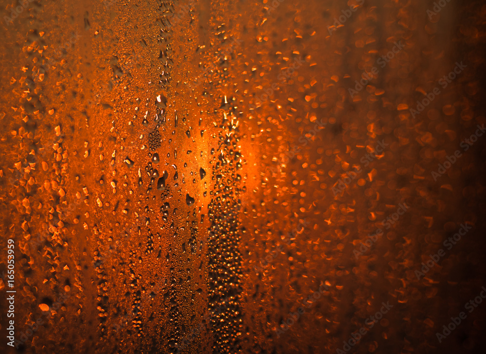 The drops on glass bokeh background.