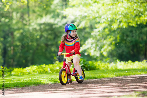 Fototapeta Naklejka Na Ścianę i Meble -  Kids ride balance bike in park