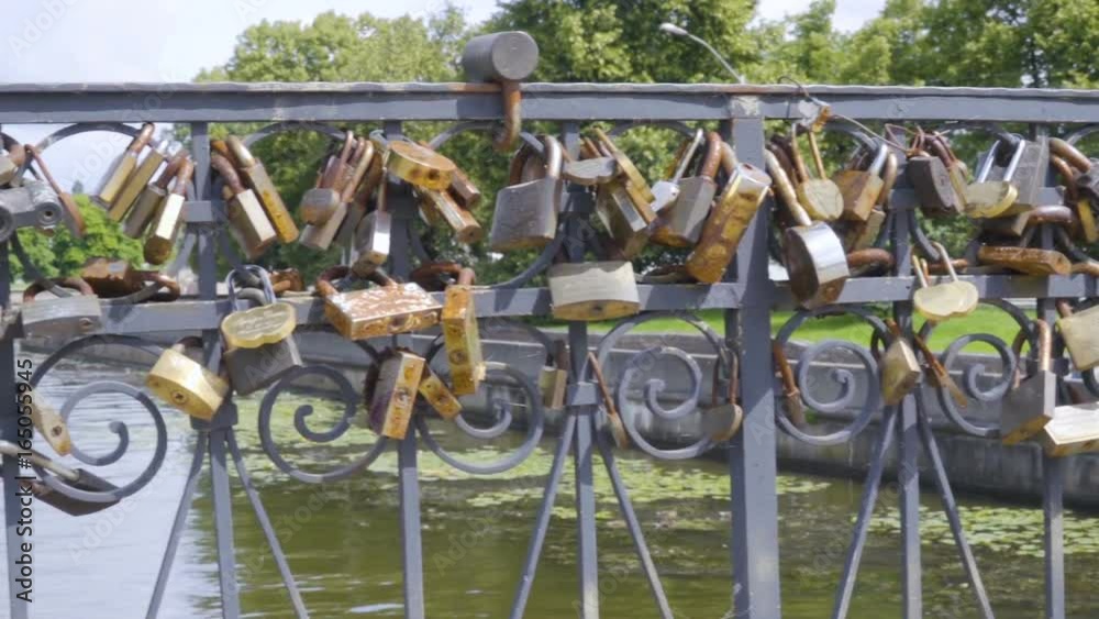 Love padlocks on the bridge. Wedding locks on a metal fencing. Love