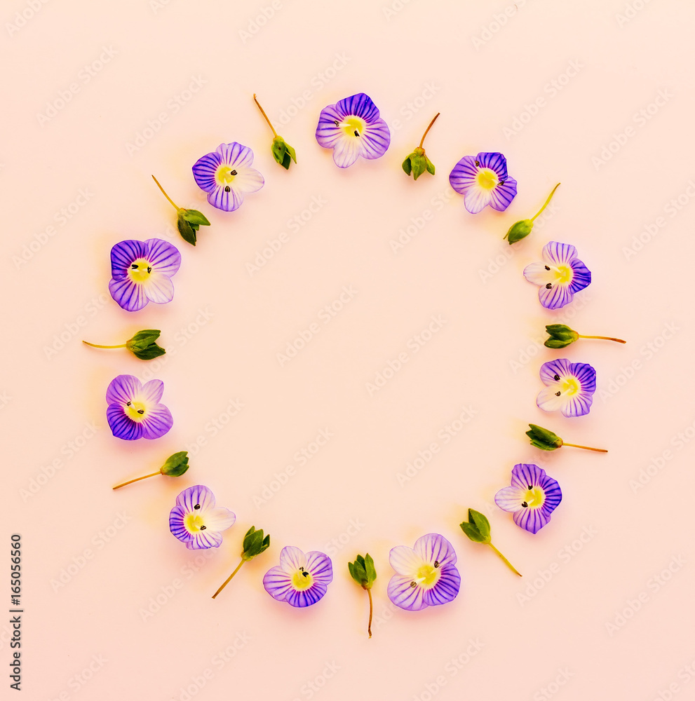 Floral round frame on a pink background, top view