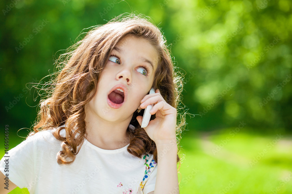 Portrait of a beautiful young little girl calling by phone Portrait of a beautiful young little girl calling by phone