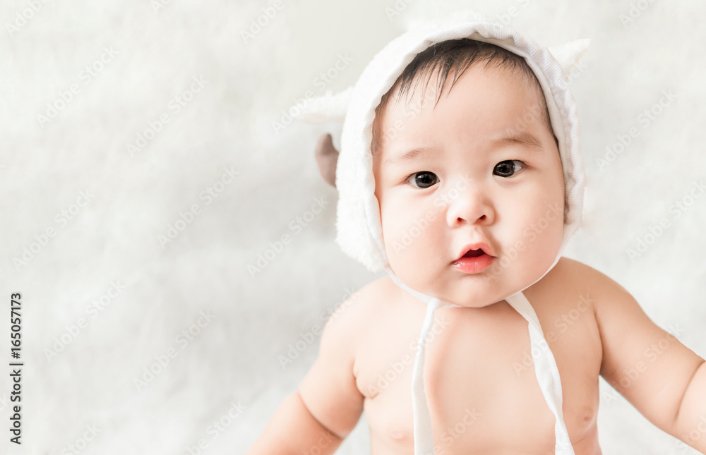 Soft focus Cute Asian male baby sitting on a towel. Blurred background. Soft focus Cute Asian male baby sitting on a towel. Blurred background.