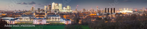 London, UK - JANUARY 7, 2016: Panoramic view from Greenwich on Canary Wharf financial district with skyscrapers at night. View includes the park, National Maritime Museum, Royal chapel and O2. photo