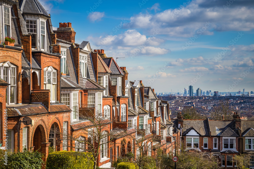 London, England - Typical brick houses and flats and panoramic view of london on a nice summer morning with blue sky and clouds taken from Muswell Hill