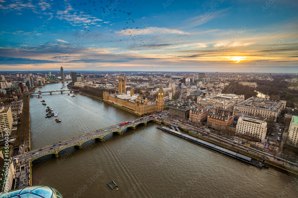 London, England - Aerial view of central London, with Big Ben, Houses of Parliament, Westminster Bridge, Lambeth Bridge at sunset with flying birds