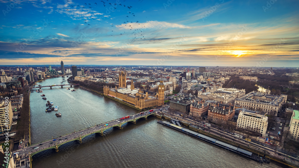 London, England - Aerial view of central London, with Big Ben, Houses of Parliament, Westminster Bridge, Lambeth Bridge at sunset with flying birds