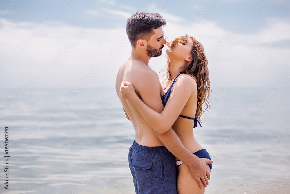 Sexy couple at sea,slim body,long hair,swimwear,swimsuit,beautiful tan,summer holidays concept,make up,bearded man Sexy couple at sea,slim body,long hair,swimwear,swimsuit,beautiful tan,summer holidays concept,make up,bearded man