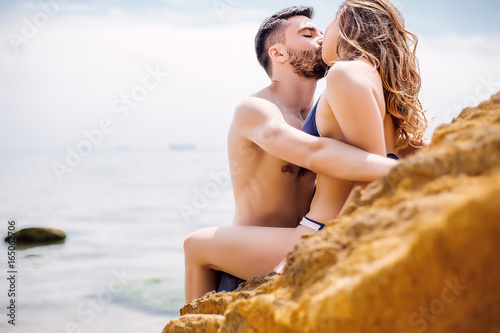 Sexy couple at sea,slim body,long hair,swimwear,swimsuit,beautiful tan,summer holidays concept,make up,bearded man