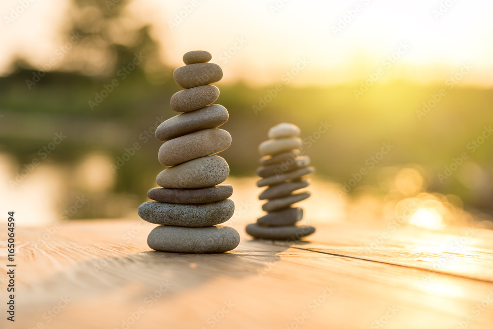 Obraz premium Zen Balancing Pebbles Next to a Misty Lake