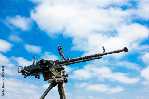 A machine gun against blue skies