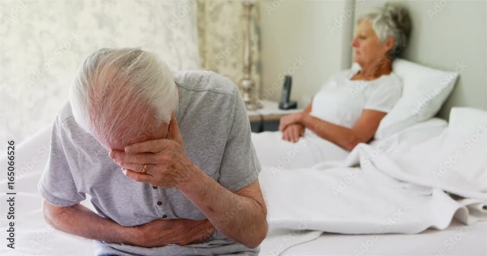 Upset senior couple arguing with each other in bedroom Upset senior couple arguing with each other in bedroom