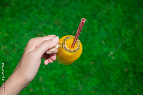 Female holding fresh orange juice