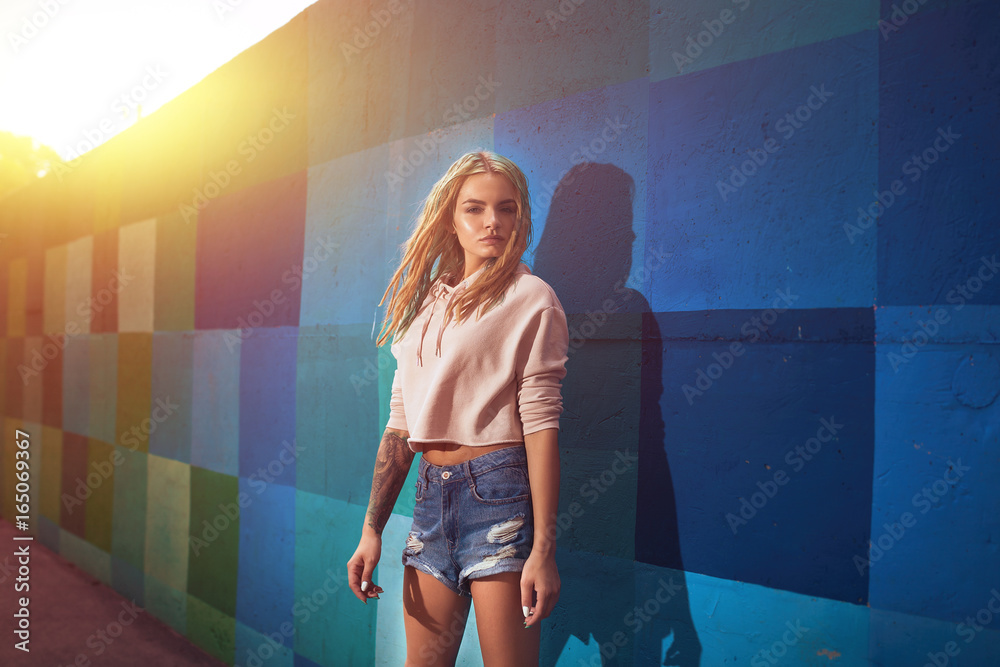 beautiful suntanned dreadlocks sexy girl in short jeans shorts and white  shirt Stock Photo | Adobe Stock