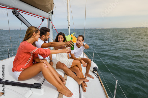 Group of friends having fun in boat in river © Luis Viegas