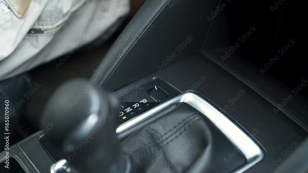 Hand switches the AUTOMATIC TRANSMISSION lever. 4K video with shallow depth of field focus on the hand Hand switches the AUTOMATIC TRANSMISSION lever. 4K video with shallow depth of field focus on the hand
