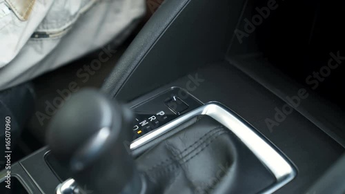 Hand switches the AUTOMATIC TRANSMISSION lever. 4K video with shallow depth of field focus on the hand