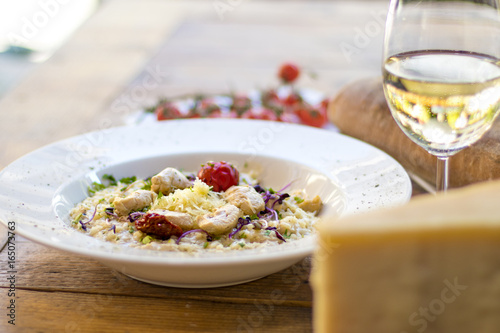 A plate of risotto with parmesan and chicken