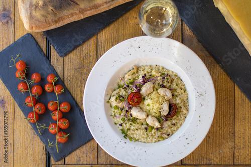 A plate of risotto with parmesan and chicken
