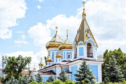 Ciuflea monastery sf teodor tiron, Chisinau, Moldova, sunny day blue sky trees and flowers photo