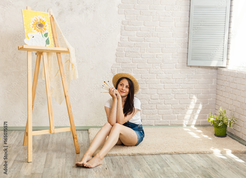 Portrait of gorgeous woman artist  painting at home