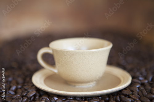 Coffee cup on coffee beans
