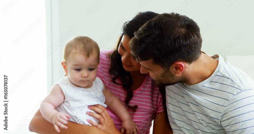 Parents playing with their baby girl in bedroom Parents playing with their baby girl in bedroom