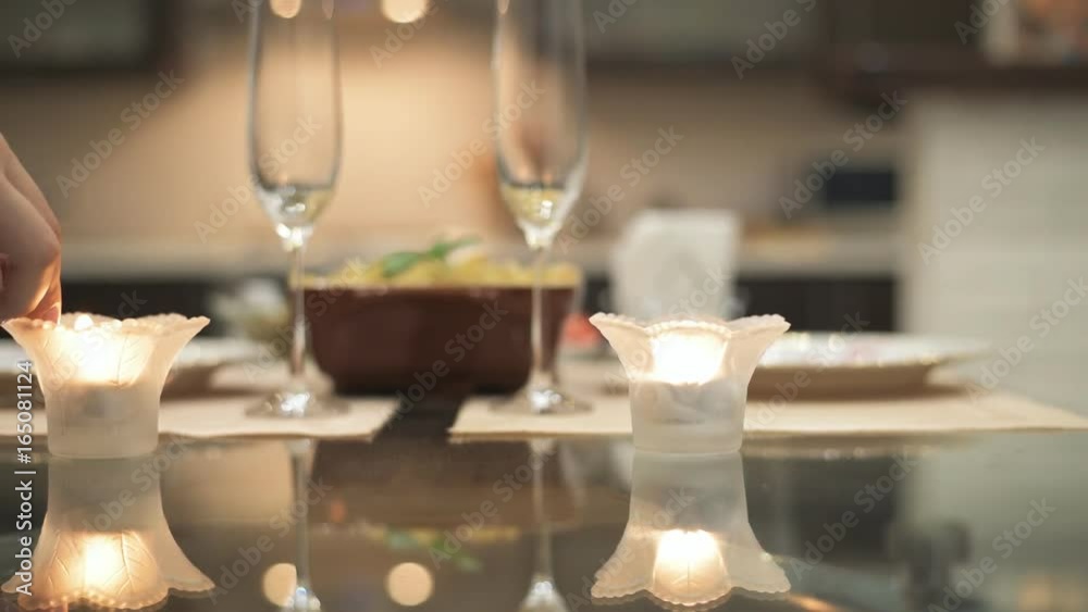 Woman lighting candles for dating. Romantic concept . Woman lighting candles for dating. Romantic concept .