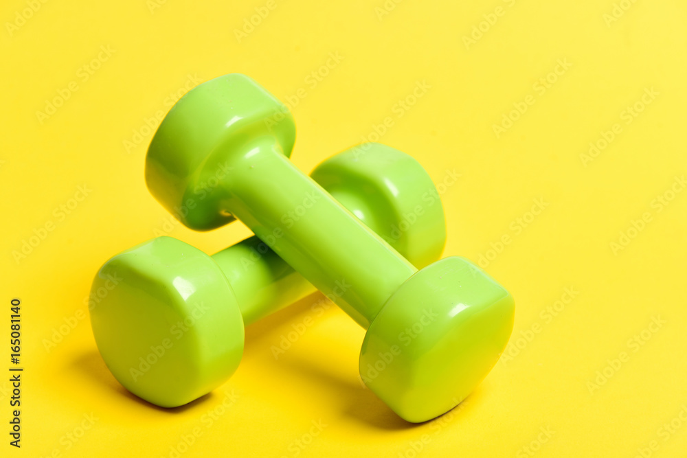 Pair of green lightweight plastic dumbbells for light training Pair of green lightweight plastic dumbbells for light training