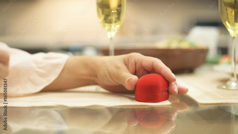 Man gives red box with engagement ring, making marriage proposal to girlfriend, requesting a hand, indoors. Romantic concept, asking to marry, birthday gift, wedding planning. Man gives red box with engagement ring, making marriage proposal to girlfriend, requesting a hand, indoors. Romantic concept, asking to marry, birthday gift, wedding planning.