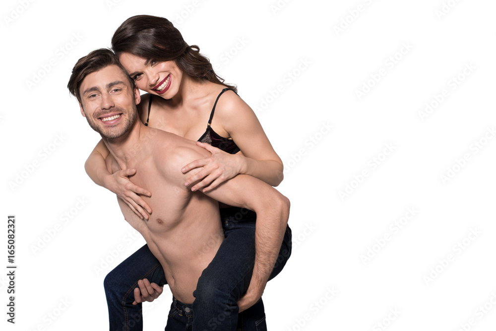 beautiful sensual couple, man giving woman piggyback ride, isolated on white beautiful sensual couple, man giving woman piggyback ride, isolated on white