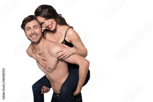 beautiful sensual couple, man giving woman piggyback ride, isolated on white