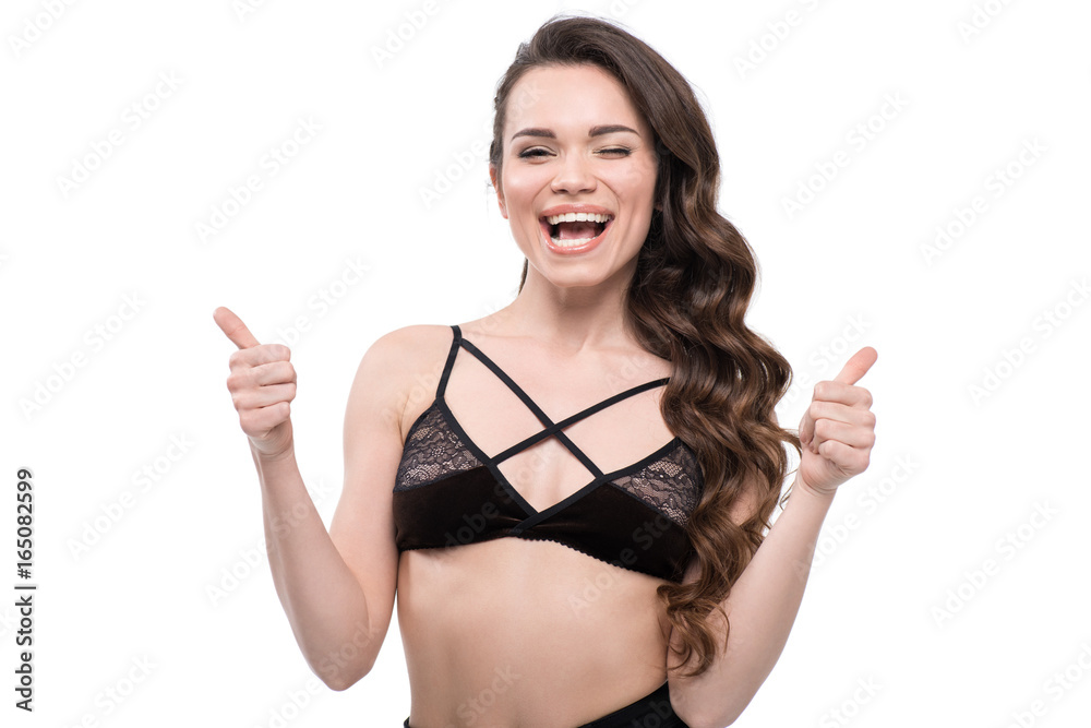 Portrait of beautiful young woman in black lingerie with thumbs up, isolated on white Portrait of beautiful young woman in black lingerie with thumbs up, isolated on white