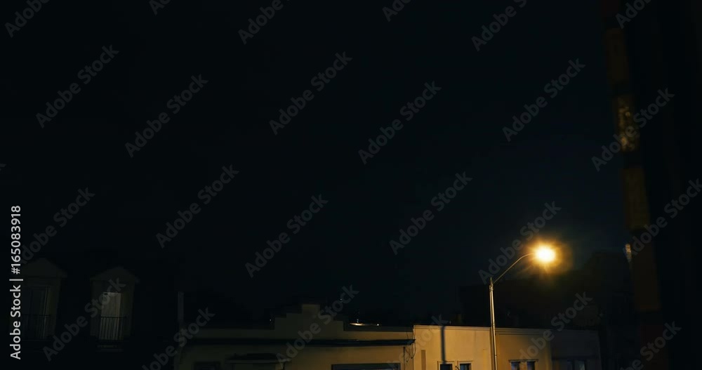 Lightning strike over buildings in a city. Storm establishing shot. Lightning strike over buildings in a city. Storm establishing shot.