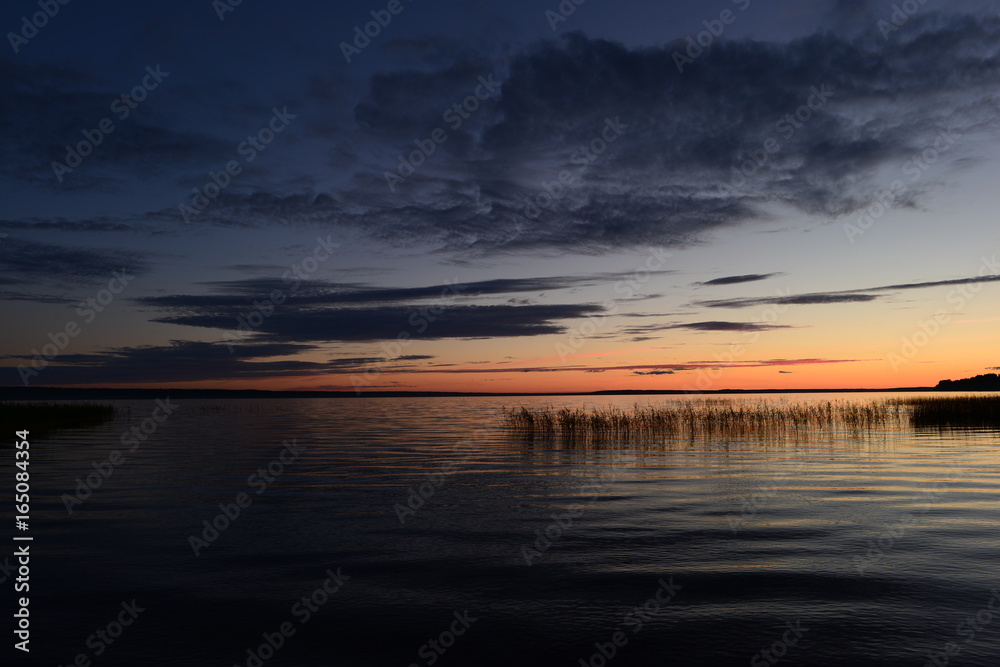 Fototapeta premium Pink strip afterglow of sunset on the horizon comes night