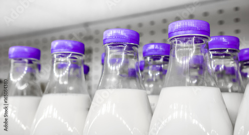 bottles with milk as dairy product for preparing breakfast wait for byers on market shelf