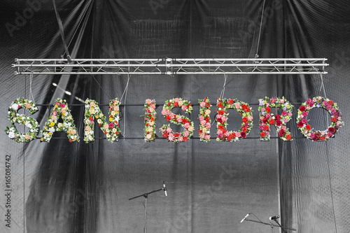 San Isidro festival signpost with flower on a stage photo