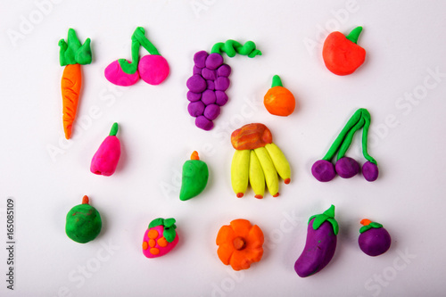 Wallpaper Mural Plasticine modeling fruits orange grapes mangosteen pumpkin mango a banana strawberry carrot eggplant apple cherry blueberries together on a white plasticine background Torontodigital.ca