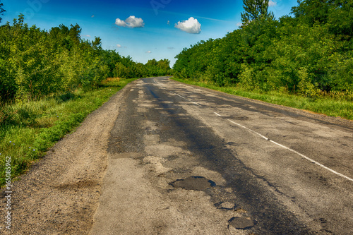 Background texture landscape old road highway with holes in the summer of HDR