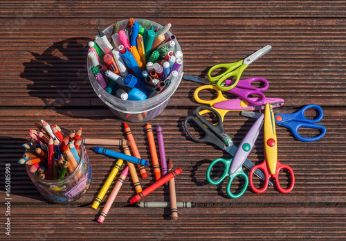 Back to school concept. Pencils markers scissors on wooden background
