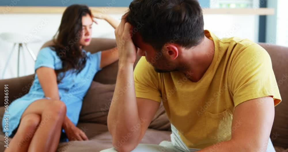 Couple ignoring each other in living room Couple ignoring each other in living room