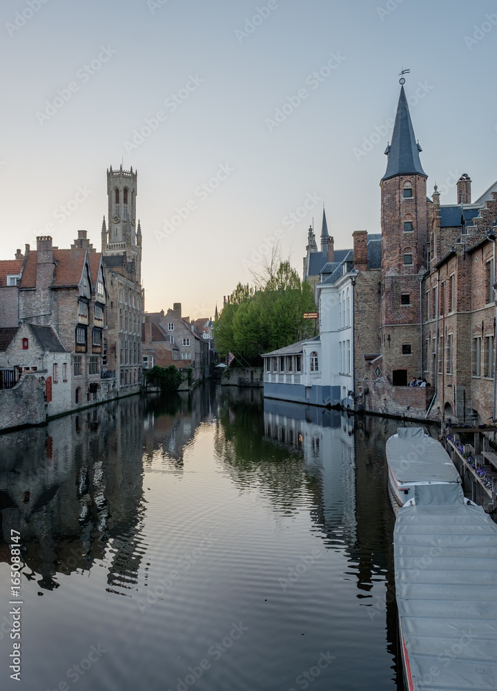Historical building reflected in a canal in Bruges